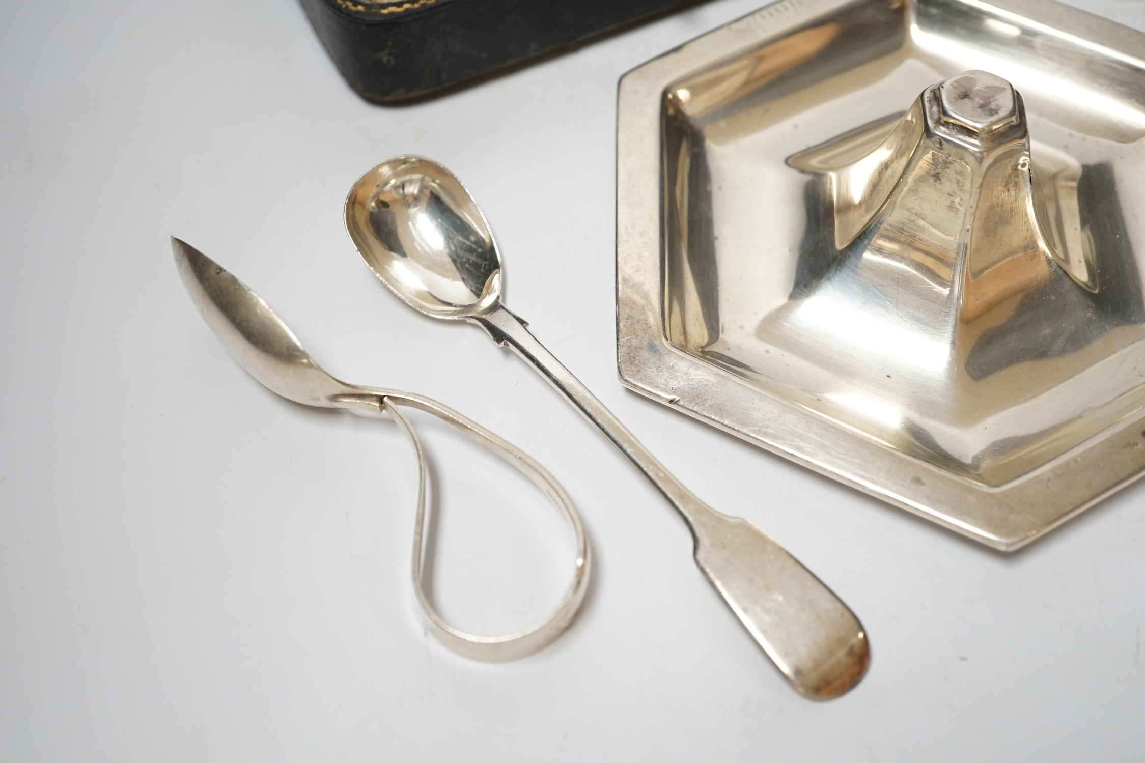 A Dutch white metal ashtray, with pierced border, 13.1cm and one other silver hexagonal ashtray?, a pair of small silver toastracks, two silver napkin rings and six items of silver flatware, including pair of Irish condi